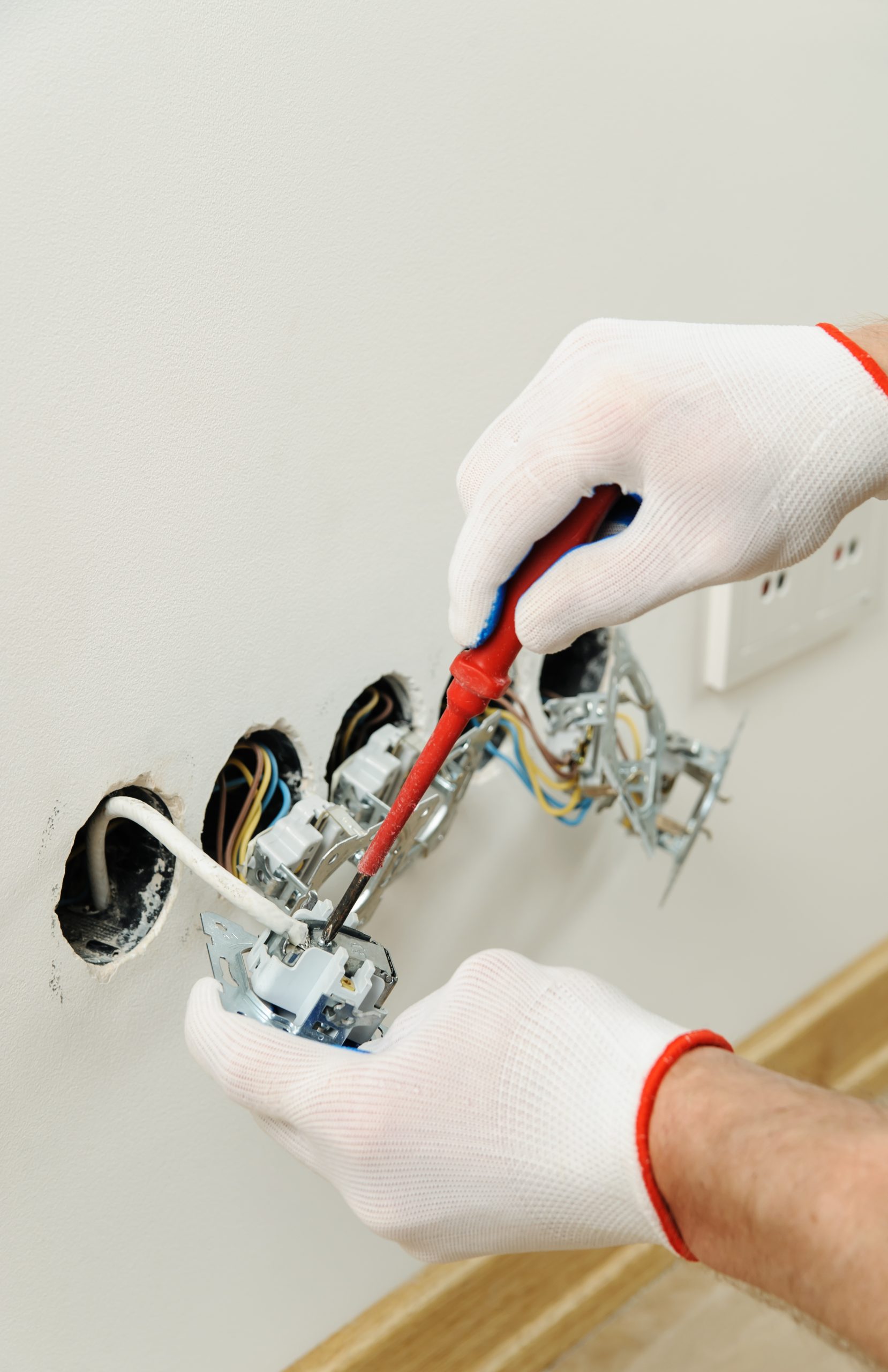 Worker installs a tv wall socket.